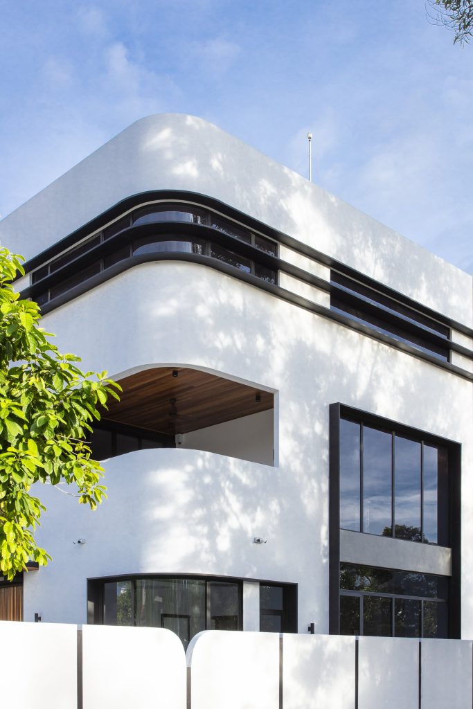 Fillet House: tree shadows across the curved exterior wall.