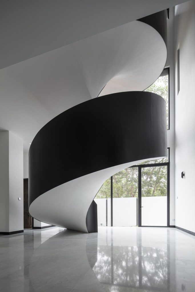 Fillet House: spiral stair reflected in the marble floor.